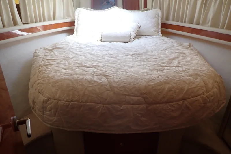 Slide: The Image of Cozy bedroom interior of 1998 Sea Ray 480 Sedan Bridge yacht with plush bedding. - 32