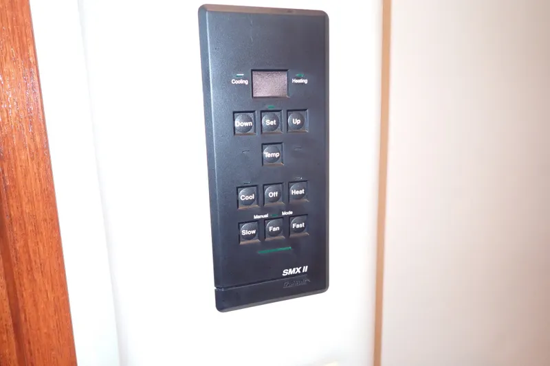 Slide: The Image of Control panel on a 1998 Sea Ray 480 Sedan Bridge yacht, featuring temperature settings. - 138