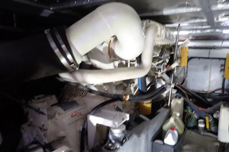 Slide: The Image of Engine room of a 1998 Sea Ray 480 Sedan Bridge with visible components and hoses. - 191