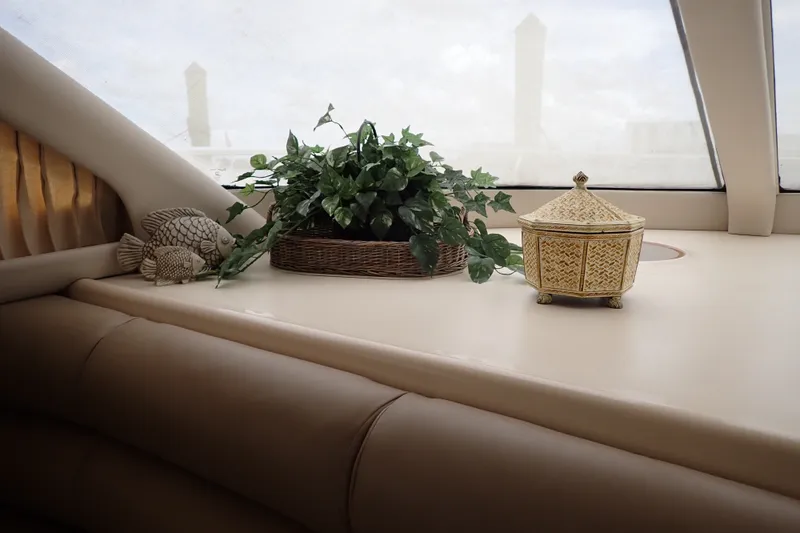 Slide: The Image of Luxurious interior of 1998 Sea Ray 480 Sedan Bridge with decor and greenery. - 131