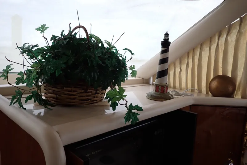 Slide: The Image of Interior of 1998 Sea Ray 480 Sedan Bridge with plant and lighthouse decor. - 132