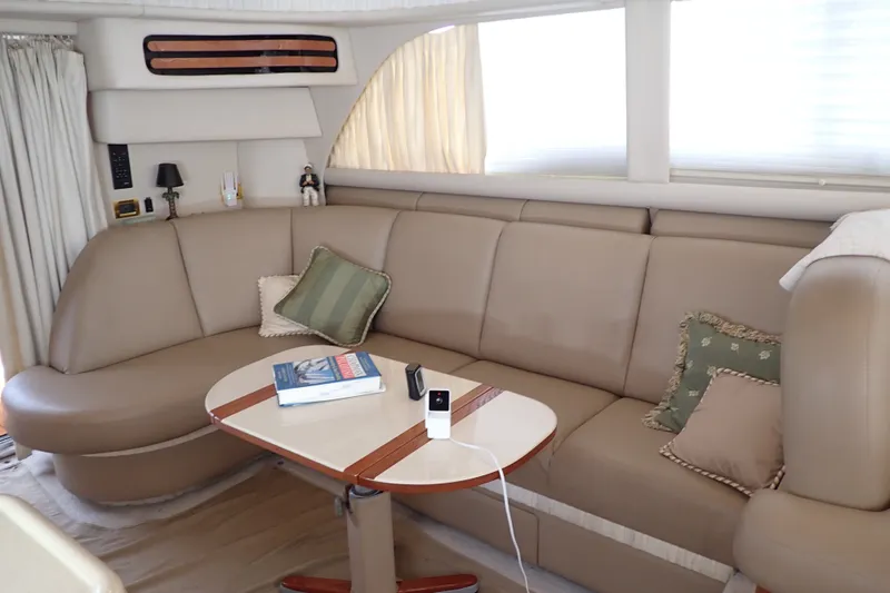 Slide: The Image of Luxurious interior of 1998 Sea Ray 480 Sedan Bridge yacht with plush seating and table. - 18