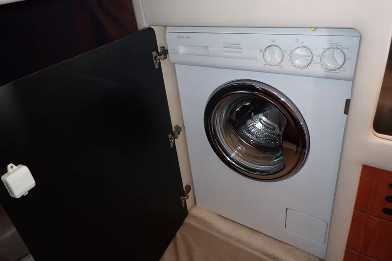 Slide: The Image of Washing machine inside 1998 Sea Ray 480 Sedan Bridge yacht, with open cabinet door. - 24
