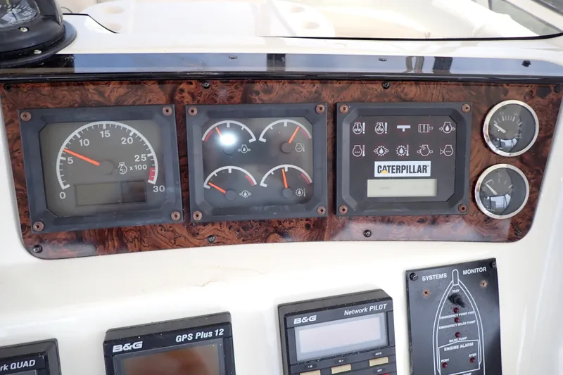 Slide: The Image of Dashboard of a 1998 Sea Ray 480 Sedan Bridge with Caterpillar engine gauges. - 45