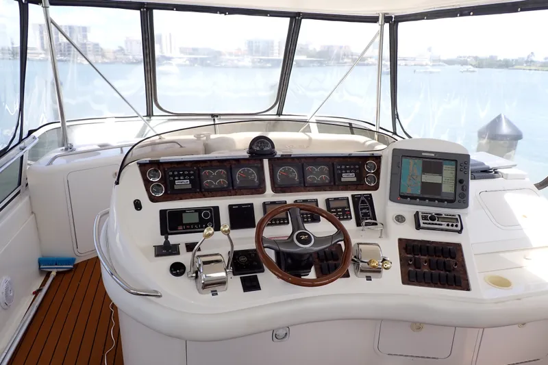 Slide: The Image of 1998 Sea Ray 480 Sedan Bridge helm with navigation instruments and steering wheel. - 7