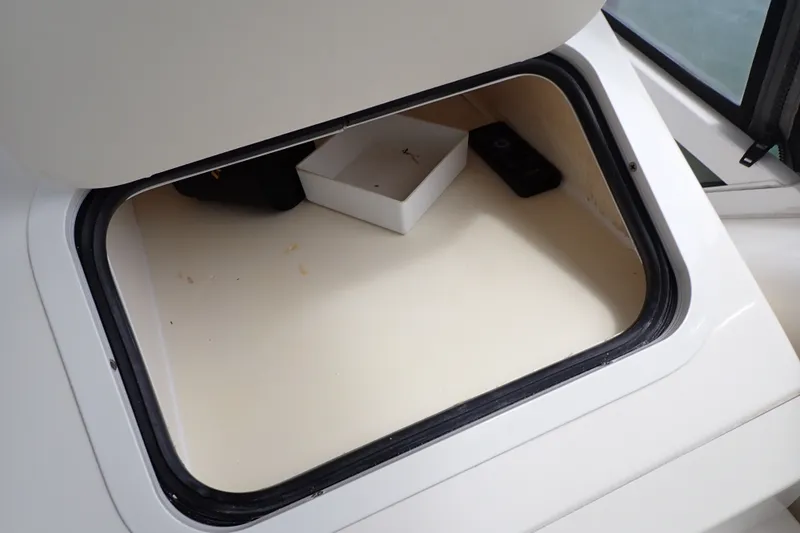 Slide: The Image of Open storage compartment on 1998 Sea Ray 480 Sedan Bridge boat. - 65