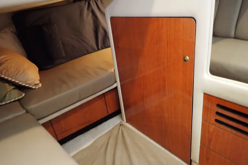 Slide: The Image of Interior cabin of 1998 Sea Ray 480 Sedan Bridge with wooden paneling and cushioned seating. - 151