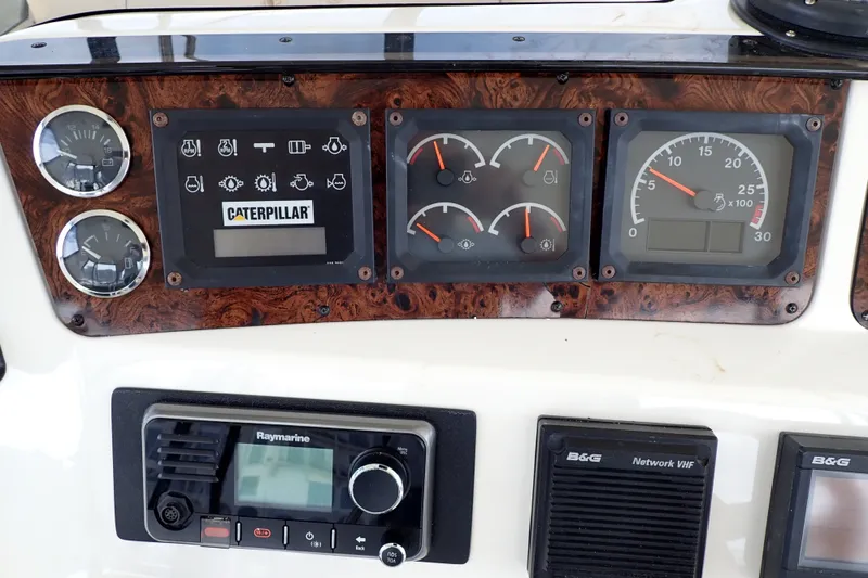 Slide: The Image of Control panel of a 1998 Sea Ray 480 Sedan Bridge with Caterpillar gauges. - 43