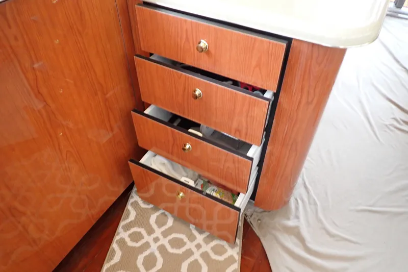Slide: The Image of Open wooden drawers inside a 1998 Sea Ray 480 Sedan Bridge yacht interior. - 117
