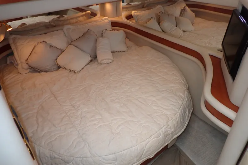 Slide: The Image of Luxurious bedroom interior of 1998 Sea Ray 480 Sedan Bridge yacht with plush bedding. - 25