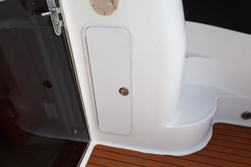 Slide: The Image of 1998 Sea Ray 480 Sedan Bridge yacht interior with sleek white panel and wooden flooring. - 69