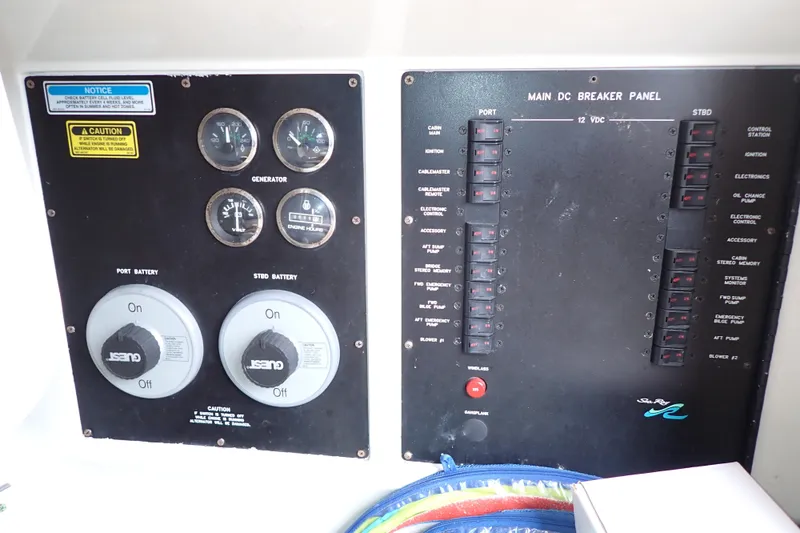 Slide: The Image of Main DC breaker panel of 1998 Sea Ray 480 Sedan Bridge with gauges and battery switches. - 73