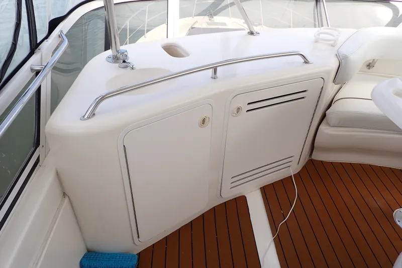 Slide: The Image of Interior view of 1998 Sea Ray 480 Sedan Bridge yacht with white cabinetry and wood flooring. - 58