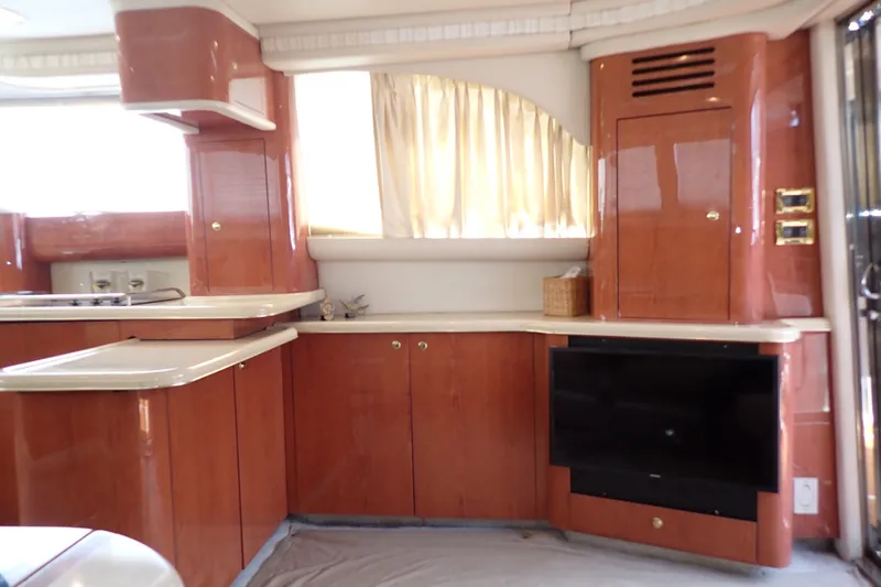 Slide: The Image of Luxurious interior of a 1998 Sea Ray 480 Sedan Bridge yacht with wood cabinetry. - 19