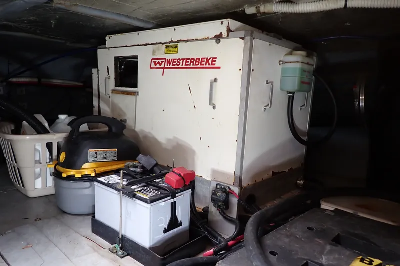 Slide: The Image of Engine room of 1998 Sea Ray 480 Sedan Bridge with Westerbeke generator and battery. - 203