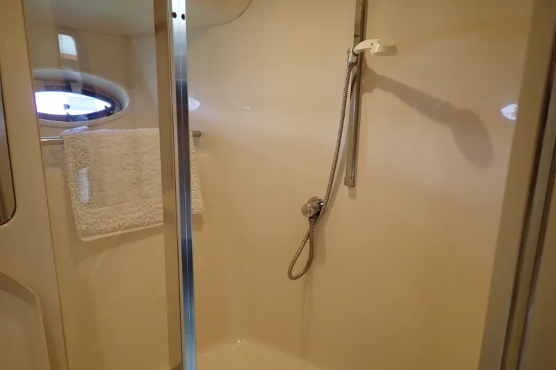 Slide: The Image of Shower area inside 1998 Sea Ray 480 Sedan Bridge yacht, featuring a handheld showerhead. - 29