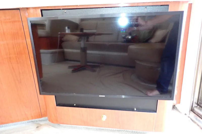 Slide: The Image of Flat-screen TV installed on a 1998 Sea Ray 480 Sedan Bridge yacht interior. - 98
