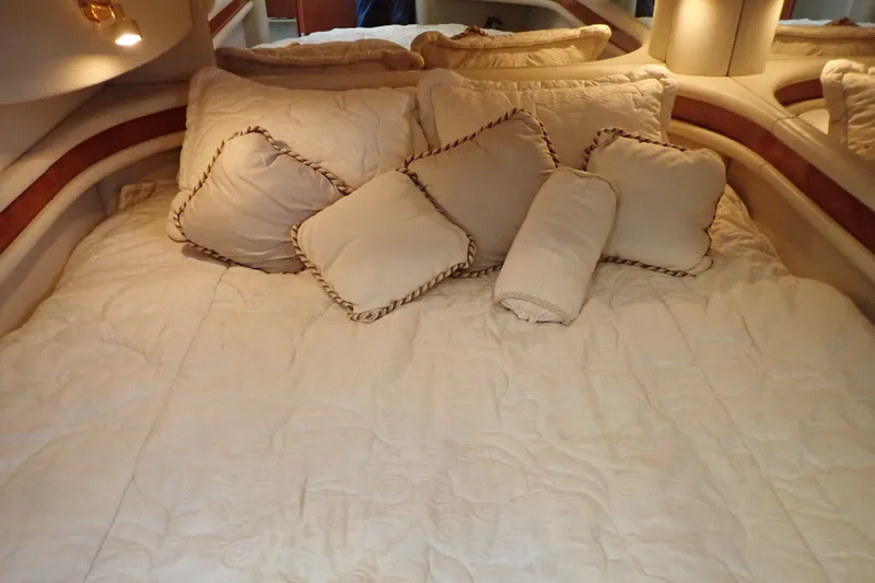 Slide: The Image of Luxurious cabin bed with plush pillows on a 1998 Sea Ray 480 Sedan Bridge yacht. - 137