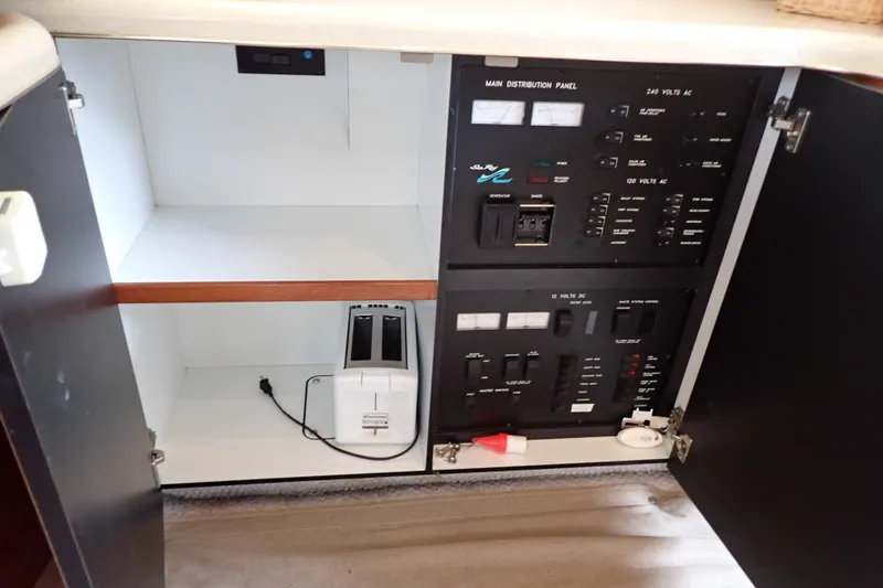 Slide: The Image of Electrical panel inside a 1998 Sea Ray 480 Sedan Bridge yacht cabinet. - 125