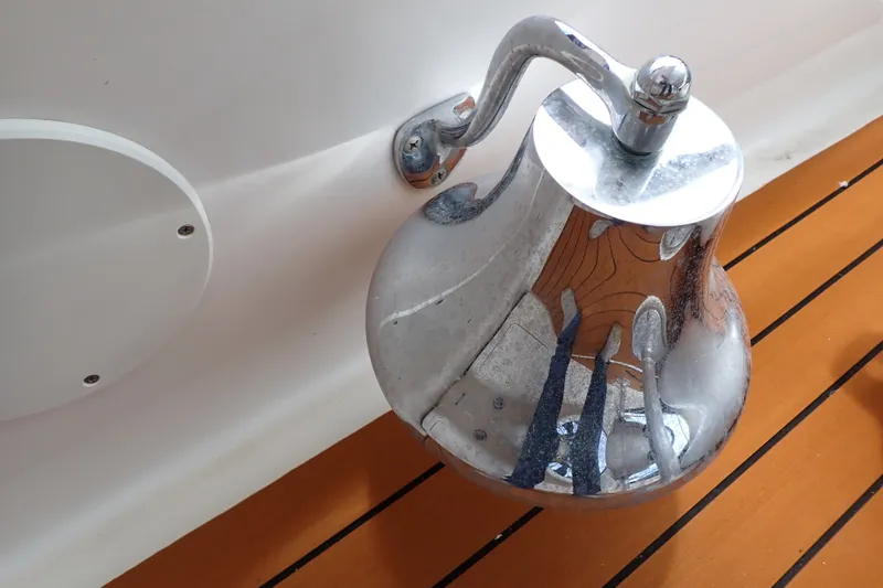 Slide: The Image of Chrome bell on 1998 Sea Ray 480 Sedan Bridge yacht, reflecting wooden deck. - 66