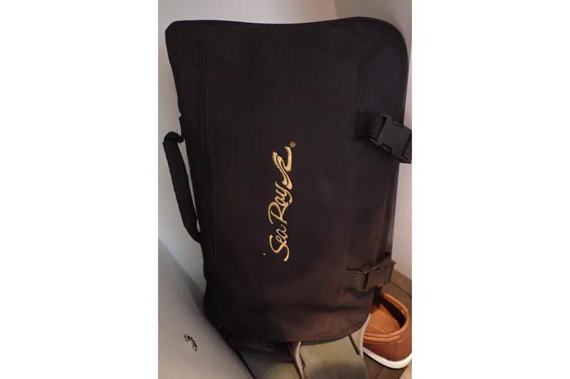 Slide: The Image of Black Sea Ray bag with gold logo, associated with 1998 Sea Ray 480 Sedan Bridge. - 169
