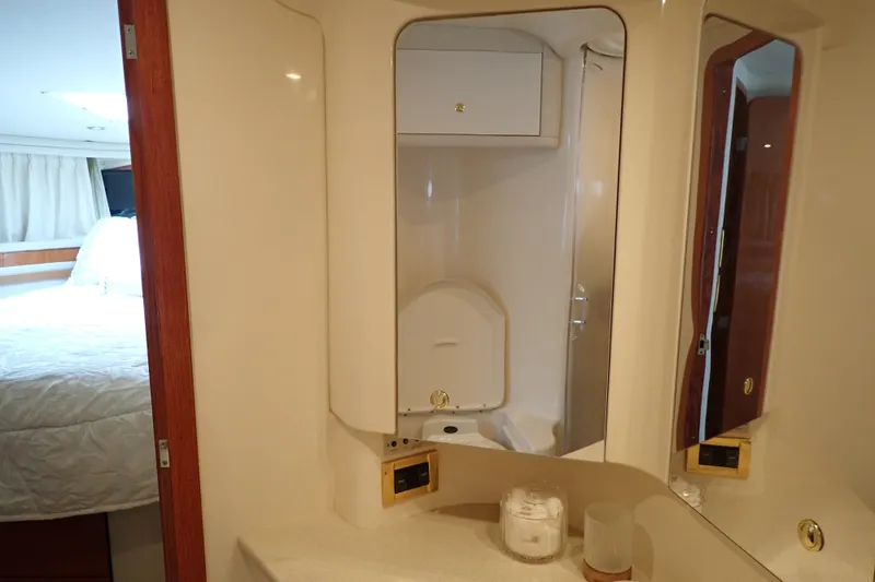Slide: The Image of Interior of 1998 Sea Ray 480 Sedan Bridge yacht, featuring a bathroom and bedroom. - 176
