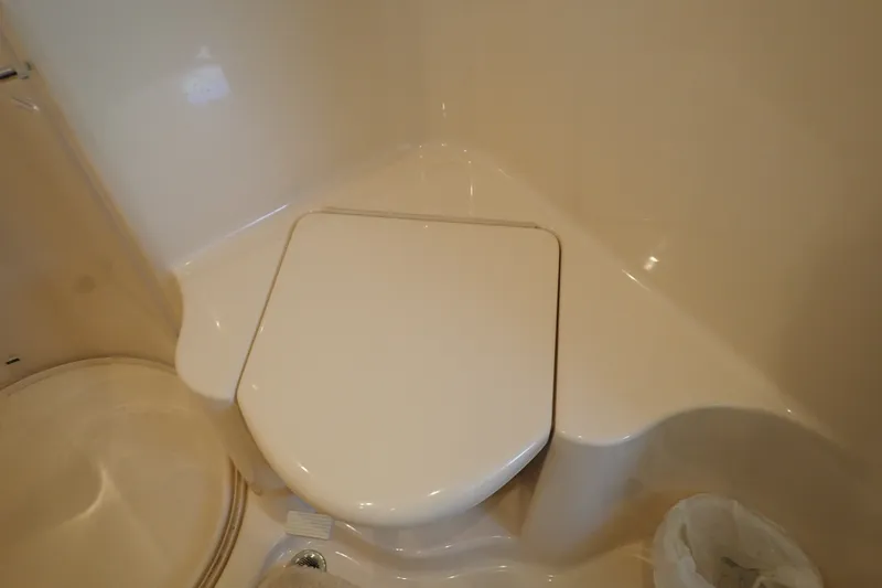Slide: The Image of 1998 Sea Ray 480 Sedan Bridge bathroom with closed toilet lid. - 38