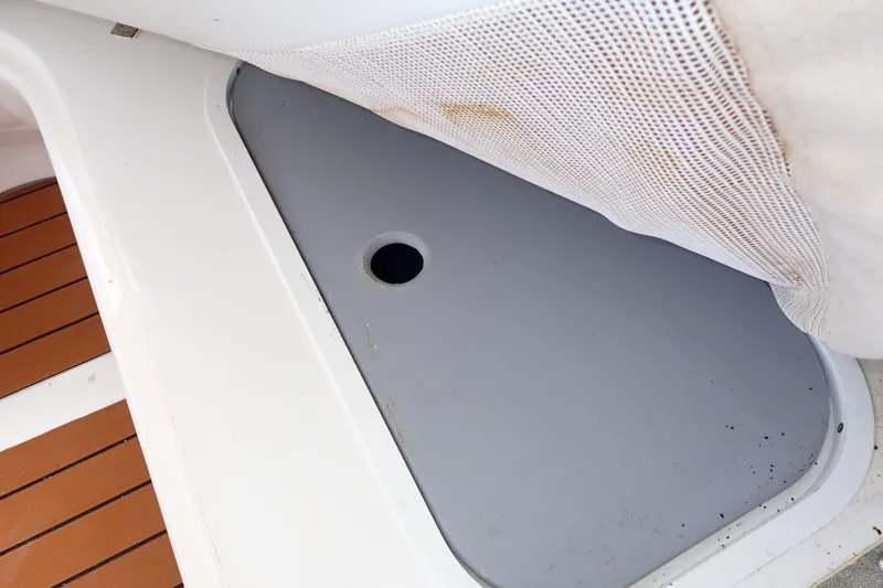 Slide: The Image of Storage compartment on 1998 Sea Ray 480 Sedan Bridge boat with wooden deck. - 61