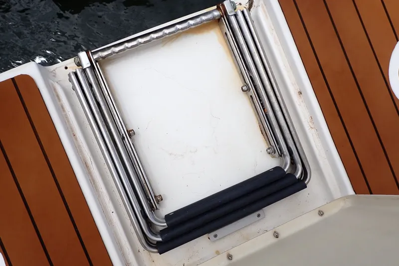 Slide: The Image of Stainless steel swim ladder on 1998 Sea Ray 480 Sedan Bridge yacht deck. - 90