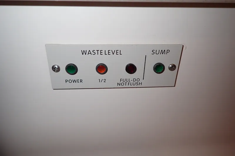 Slide: The Image of Control panel on a 1998 Sea Ray 480 Sedan Bridge yacht, showing waste level indicators. - 160