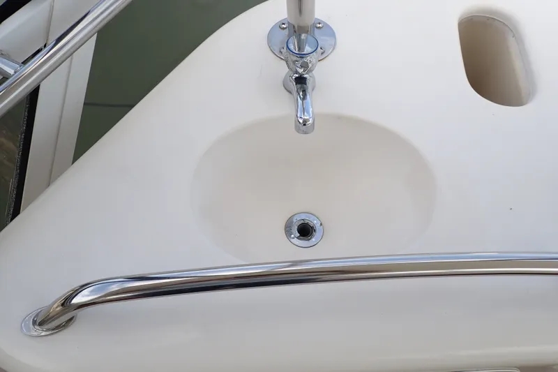 Slide: The Image of Sink and faucet on 1998 Sea Ray 480 Sedan Bridge yacht deck. - 59