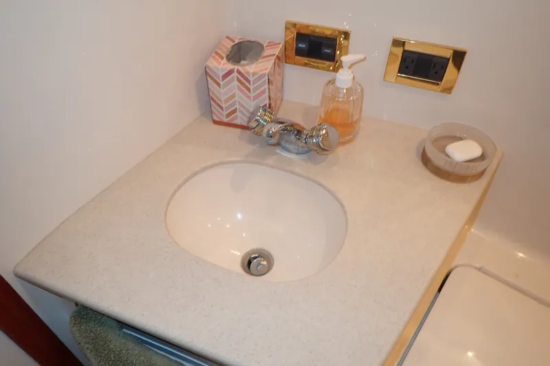 Slide: The Image of Bathroom sink area on a 1998 Sea Ray 480 Sedan Bridge yacht. - 156