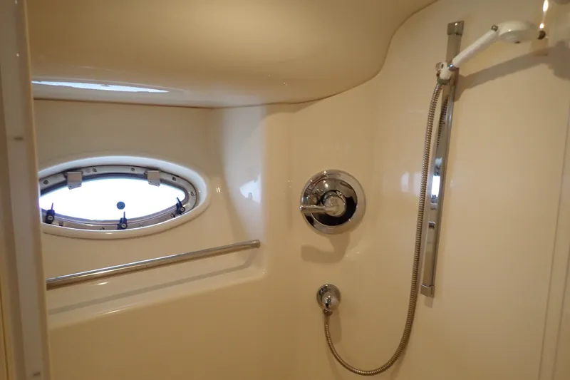 Slide: The Image of Shower area in 1998 Sea Ray 480 Sedan Bridge yacht with porthole window. - 187