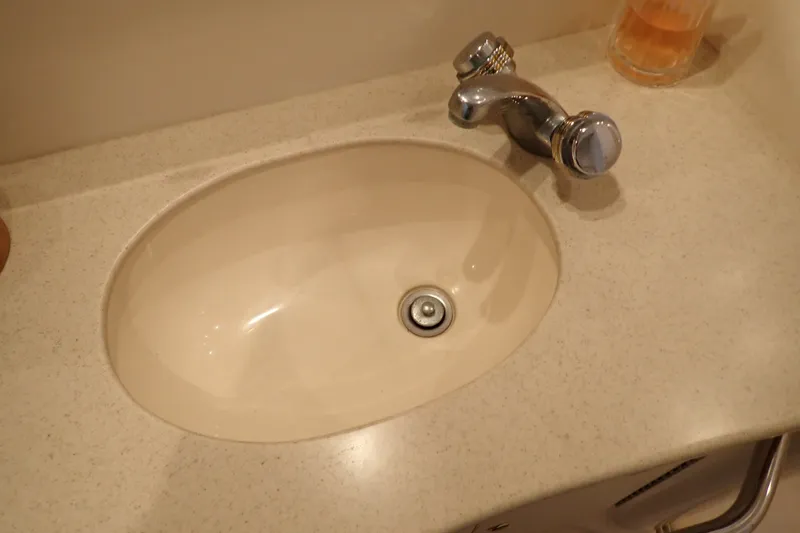 Slide: The Image of Bathroom sink with chrome faucet on 1998 Sea Ray 480 Sedan Bridge yacht. - 178