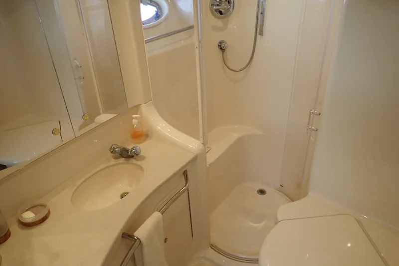 Slide: The Image of Bathroom interior of 1998 Sea Ray 480 Sedan Bridge yacht, featuring sink and shower. - 34