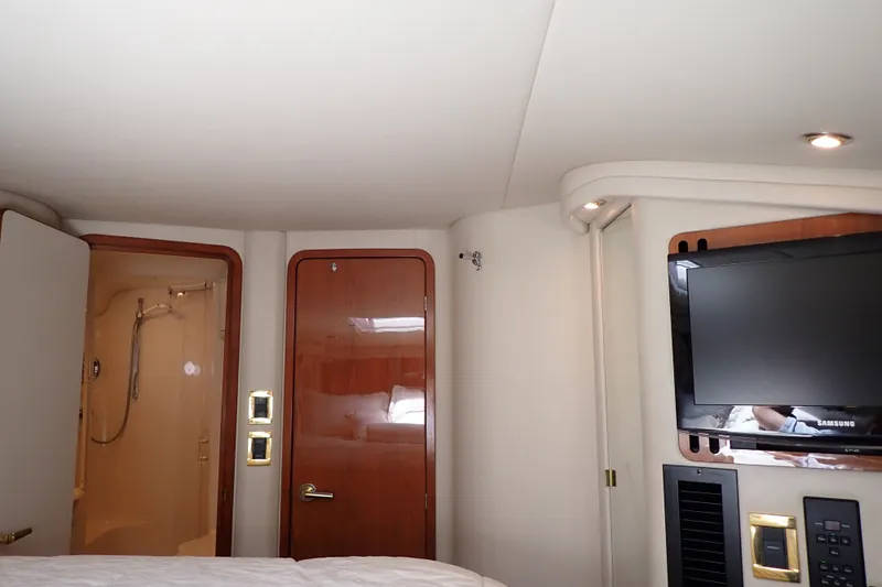 Slide: The Image of Interior of 1998 Sea Ray 480 Sedan Bridge yacht with TV and bathroom. - 33