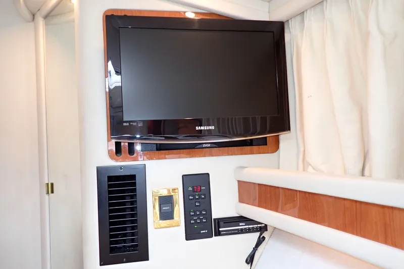 Slide: The Image of Samsung TV and control panel inside 1998 Sea Ray 480 Sedan Bridge yacht cabin. - 165