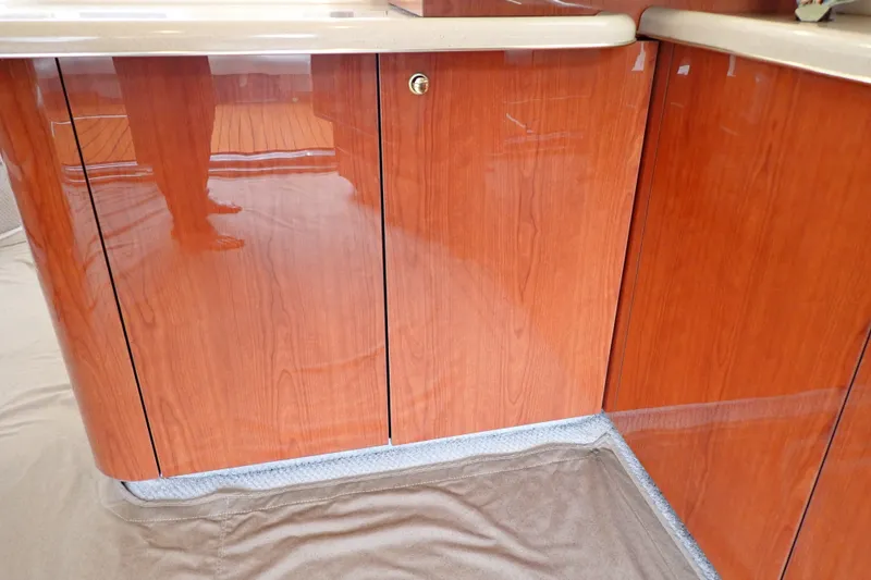 Slide: The Image of Polished wood cabinetry inside a 1998 Sea Ray 480 Sedan Bridge yacht. - 122