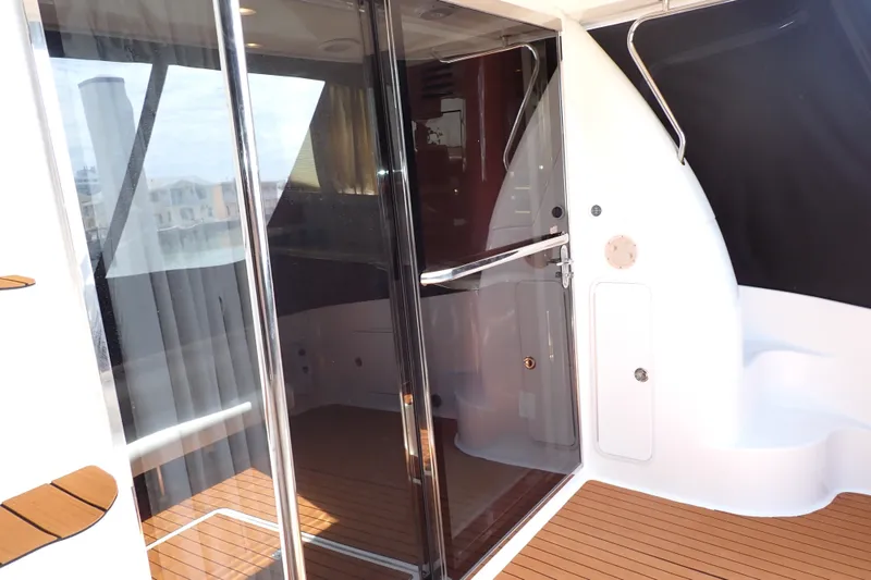 Slide: The Image of 1998 Sea Ray 480 Sedan Bridge yacht with sleek glass doors and teak flooring. - 13