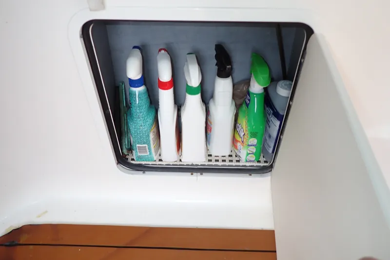 Slide: The Image of Cleaning supplies stored in a compartment on a 1998 Sea Ray 480 Sedan Bridge boat. - 78