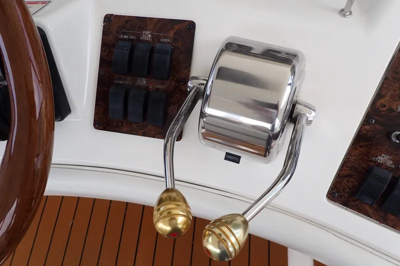 Slide: The Image of Throttle controls on a 1998 Sea Ray 480 Sedan Bridge yacht dashboard. - 51
