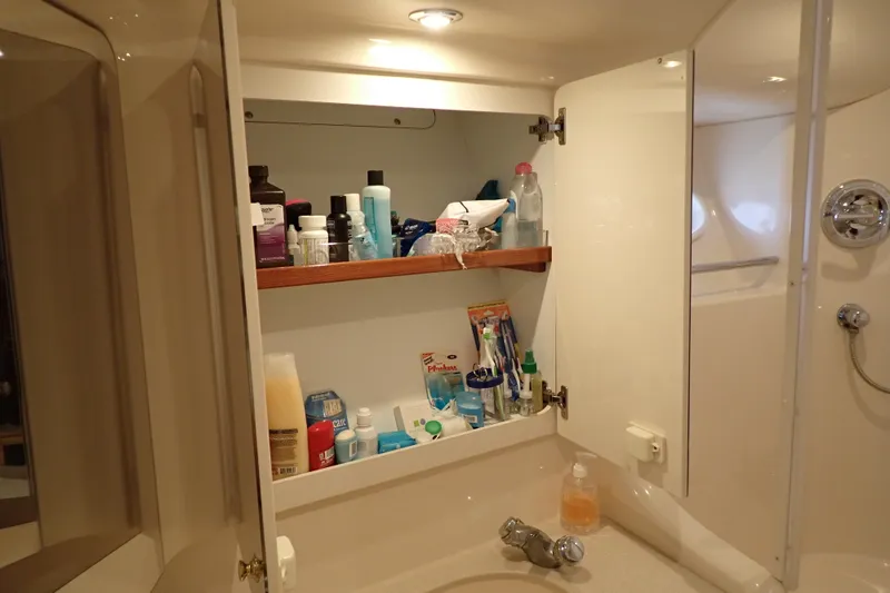 Slide: The Image of Bathroom cabinet with toiletries on a 1998 Sea Ray 480 Sedan Bridge yacht. - 175
