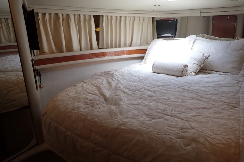 Slide: The Image of Luxurious bedroom interior of 1998 Sea Ray 480 Sedan Bridge yacht with cozy bedding. - 40