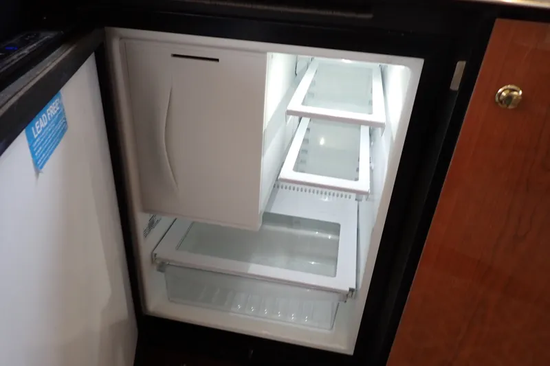 Slide: The Image of Open refrigerator inside a 1998 Sea Ray 480 Sedan Bridge yacht. - 107