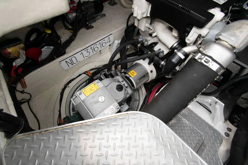 Slide: The Image of Engine compartment of a 2014 Formula 40 Performance Cruiser, showcasing mechanical components and serial number. - 24