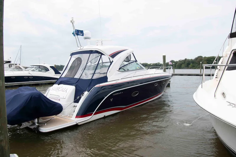 Slide: The Image of 2014 Formula 40 Performance Cruiser docked at marina, sleek design, calm waters. - 2