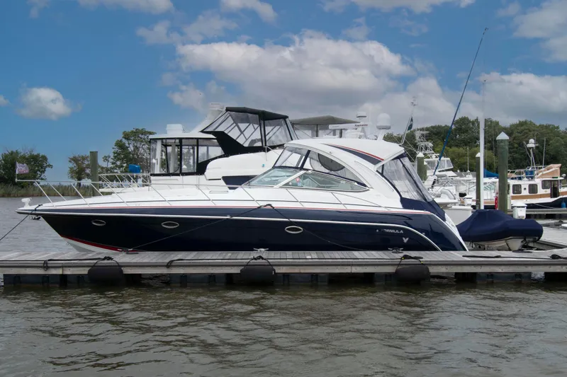 Slide: The Image of 2014 Formula 40 Performance Cruiser docked at marina under blue sky. - 1