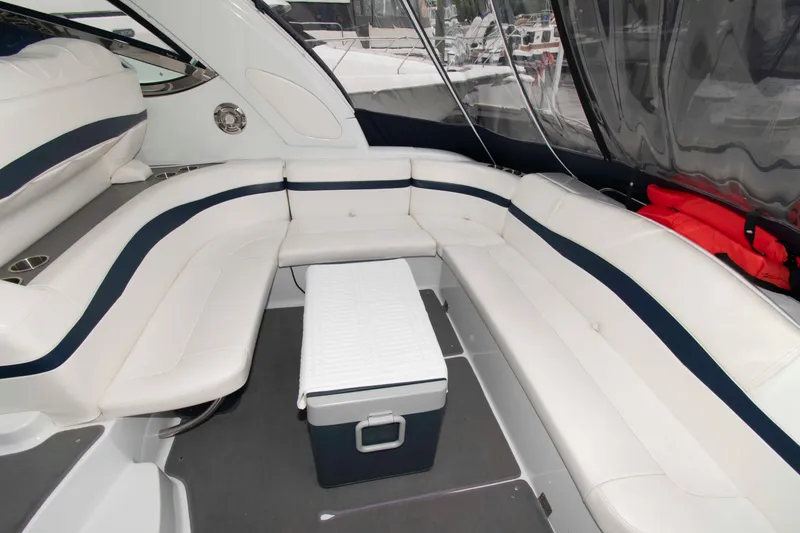 Slide: The Image of Luxurious interior of a 2014 Formula 40 Performance Cruiser with white seating and a cooler. - 11