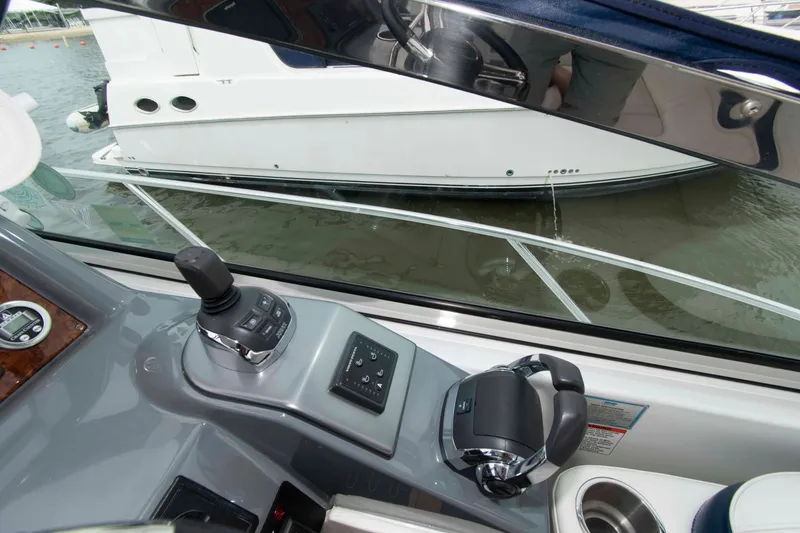 Slide: The Image of Helm of 2014 Formula 40 Performance Cruiser with joystick control, docked near another boat. - 10