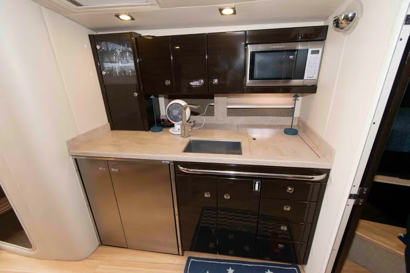 Slide: The Image of 2014 Formula 40 Performance Cruiser kitchen with modern appliances and sleek cabinetry. - 16